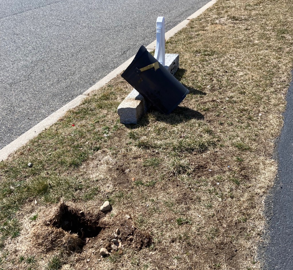 Mailbox plowed to the ground. The rest of the post is still buried.  