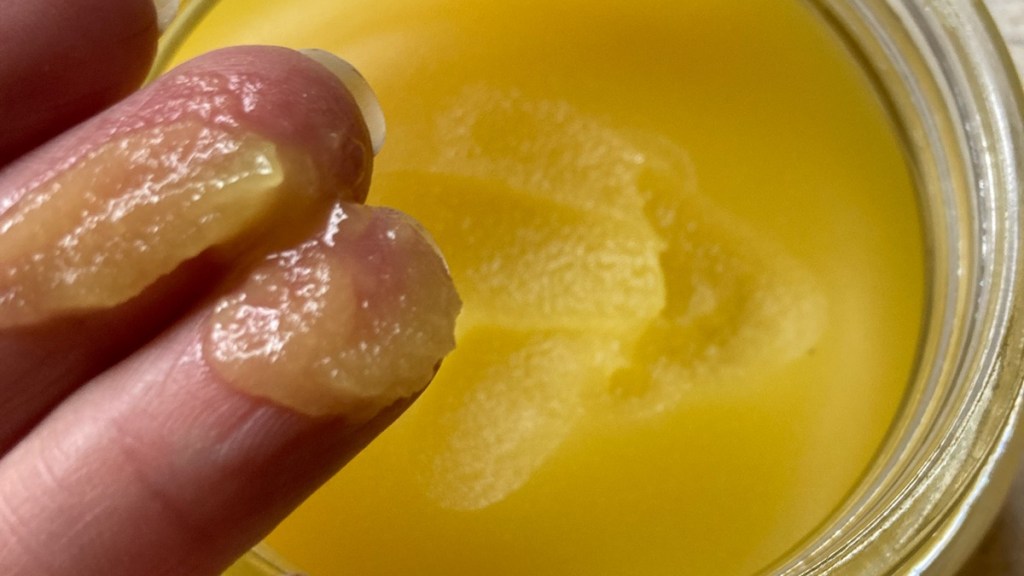 the salve consistency shown in jar and on fingers
