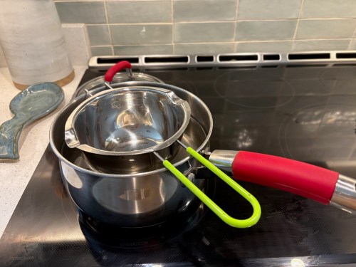 a double boiler rests on an induction cook top